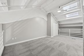 Dayton apartment for rent - A spacious room with a carpeted floor and a skylight.