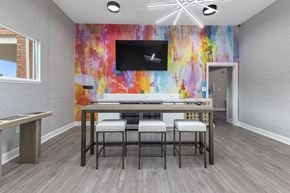 West Carrollton apartment for rent - a dining room with a table and chairs and a tv at Indian Lookout Apartments, Ohio
