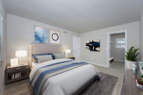 Cincinnati apartment for rent - A bedroom with a large bed and a painting on the wall.