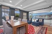 Cincinnati apartment for rent - A modern dining room with a wooden table and grey chairs.
