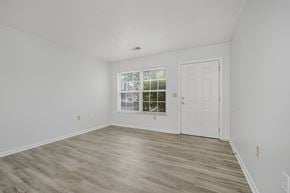 Cincinnati apartment for rent - A room with a white door and a window with a view of trees.