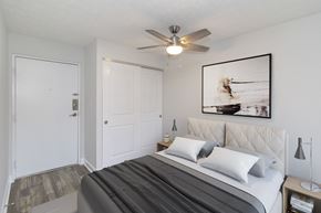 Cincinnati apartment for rent - a bedroom with a bed and a ceiling fan