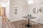 Perrysburg apartment for rent - a dining area with a table and chairs and a hallway in the background  at Waterstone Landing, Ohio, 43551