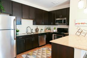Cincinnati apartment for rent - a kitchen with black cabinets and stainless steel appliances