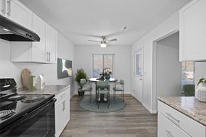 Hamilton apartment for rent - A kitchen with a table and chairs in the middle.