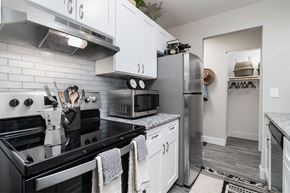Cincinnati apartment for rent - a kitchen with stainless steel appliances and white cabinets at The Heights Apartments, Cincinnati, Ohio
