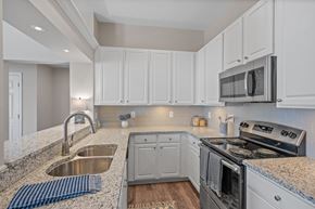 Maineville apartment for rent - A modern kitchen with a stainless steel oven and microwave.