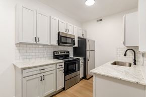 Columbus apartment for rent - a kitchen with white cabinets and stainless steel appliances at Prescott Place, Columbus, Ohio