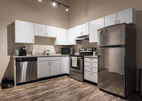 Cincinnati apartment for rent - a kitchen with stainless steel appliances and white cabinets