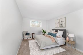 Kettering apartment for rent - A bedroom with a large bed and a chair at The Alpine Apartments, Kettering