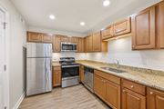 Cincinnati apartment for rent - a kitchen with wooden cabinets and stainless steel appliances at Harpers Point Apartments, Cincinnati, OH, 45249