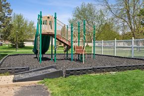 Findlay apartment for rent - A playground with a green slide and a brown and green play structure.