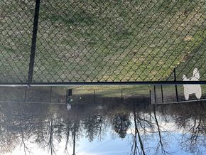 Cincinnati apartment for rent - A black fence with a green grass field in the background.