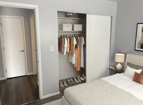 Dayton apartment for rent - A bedroom with a bed, a wardrobe, and a painting on the wall.