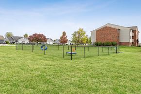 Findlay apartment for rent - A playground with a swing set and a slide in a grassy area.