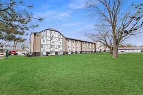 Kettering apartment for rent - A large grassy field in front of a building at The Alpine Apartments, Kettering, OH, 45429