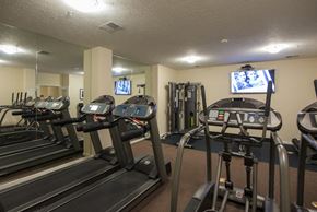 Cincinnati apartment for rent - A gym with treadmills and exercise equipment.