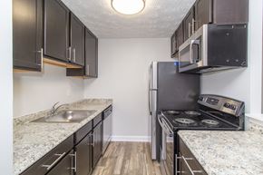 Cincinnati apartment for rent - a kitchen with granite counter tops and a stainless steel refrigerator