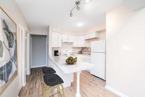 Kettering apartment for rent - A kitchen with a white fridge, a white table and black chairs at The Alpine Apartments, Kettering, 45429
