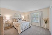 Centerville apartment for rent - Bright bedroom with neutral tones and carpeted flooring at Normandy Club Apartments, Centerville, OH 45459