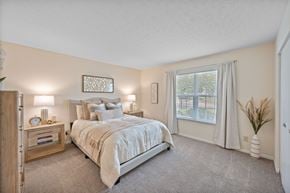 Centerville apartment for rent - A bedroom with a large bed and a window with curtains.