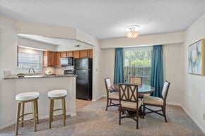 Centerville apartment for rent - A kitchen with a black refrigerator and white cabinets.