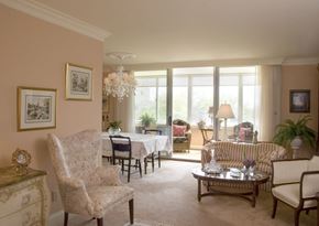 Cincinnati condo for rent - A living room with a chair, a sofa, a coffee table, and a chandelier.