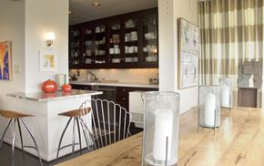 Cincinnati condo for rent - A kitchen with a white counter and brown chairs.