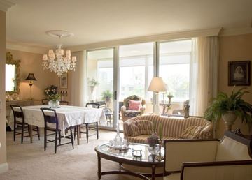 Cincinnati condo for rent - A well-lit living room with a dining table and chairs.