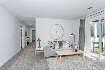 Cincinnati apartment for rent - a living room with a couch and a clock on the wall