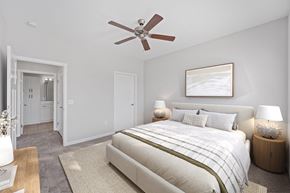 Newport apartment for rent - A bedroom with a large bed and a ceiling fan. at Monmouth Row Apartments, Newport, KY