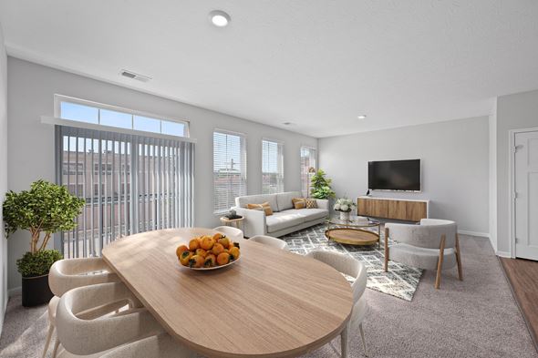 Newport apartment for rent - A modern living room with a wooden table and white chairs. at Monmouth Row Apartments, Newport, 41071