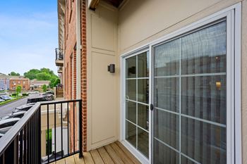 The view from the balcony of an apartment building with a glass door