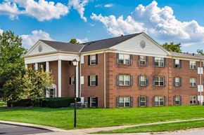 Columbus apartment for rent - Three story brick building with white gabled roofline at Northtowne Apartments, Ohio, 43229