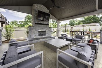 The outdoor patio has a fireplace and couches and tables