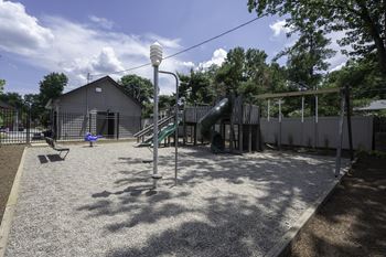 A playground with a slide and a swing set