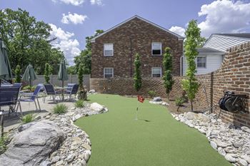 The backyard of a house with a golf course in front of it