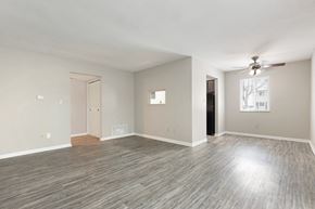 Columbus apartment for rent - A spacious room with a ceiling fan and light wood flooring.
