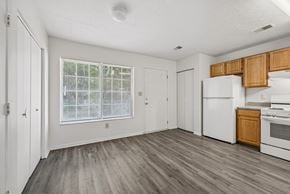 Cincinnati apartment for rent - A kitchen with white appliances and wooden cabinets.