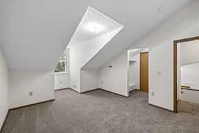 Columbus apartment for rent - A spacious room with a skylight and carpeted floor.