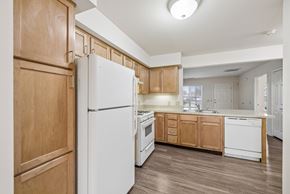 Columbus apartment for rent - A kitchen with wooden cabinets and a white refrigerator.