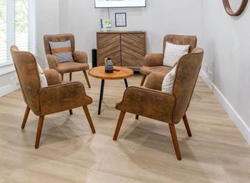 Lexington apartment for rent - A living room with a brown chair and a brown table.