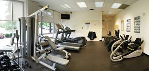 Cincinnati condo for rent - A gym with a variety of equipment including treadmills, weight machines, and free weights.