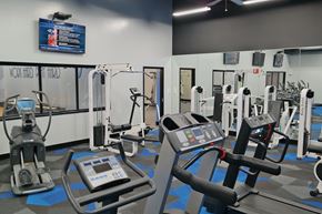 Cincinnati apartment for rent - a gym with various cardio machines and weights