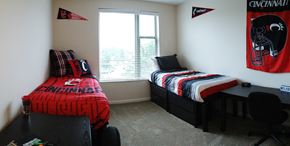 Cincinnati apartment for rent - a bedroom with two beds and a desk and a window