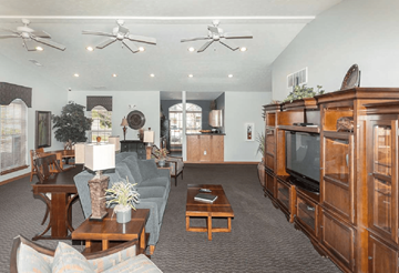Indianapolis apartment for rent - A living room with a grey couch and wooden furniture.
