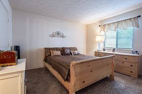 Crawfordsville apartment for rent - a bedroom with a bed and dresser and a window