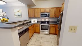 Cincinnati apartment for rent - a kitchen with wooden cabinets and stainless steel appliances