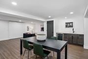 Kettering townhouse for rent - a dining area with a table and chairs and a kitchen in the background