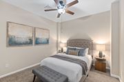 Cincinnati apartment for rent - A bedroom with a large bed and a ceiling fan.